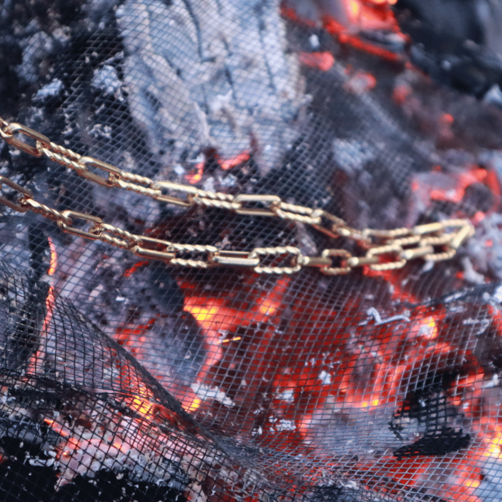 Gold Chain Necklace On Black Screen Over Glowing Hot Coals Jewelry Photo Shoot