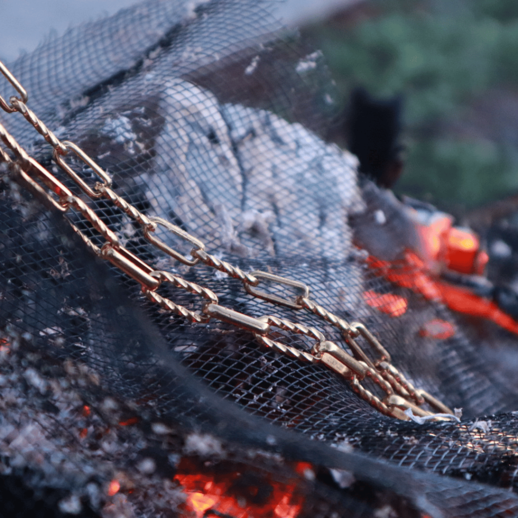 Gold Chain Necklace On Black Screen Over Glowing Hot Coals Jewelry Photo Shoot