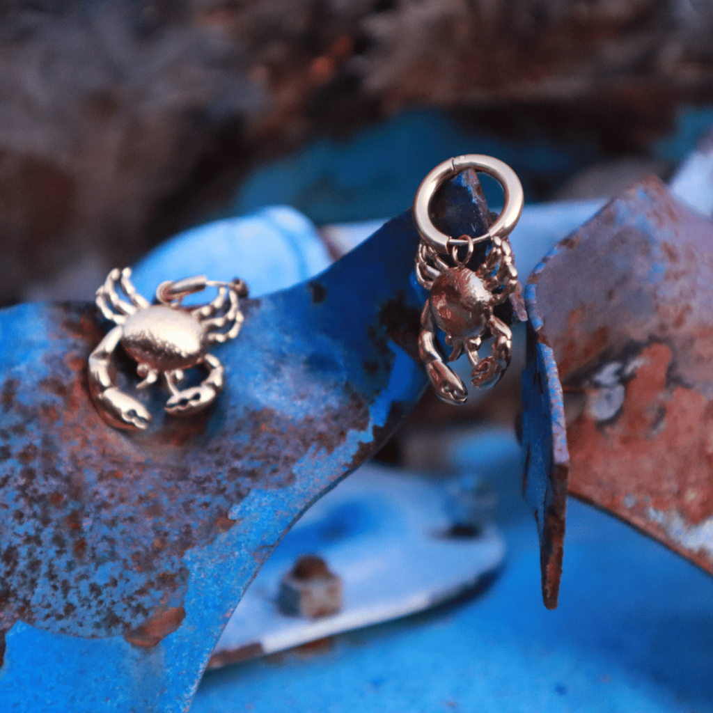 Gold Crab Earrings On Blue Rusty Tank Jewelry Photo Shoot