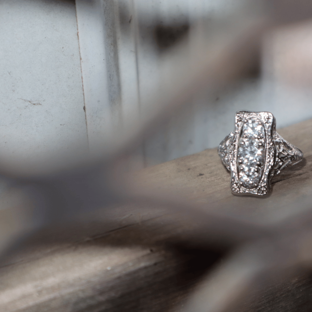 Silver Diamond Ring Behind An Out Of Focus Fence Jewelry Photo Shoot